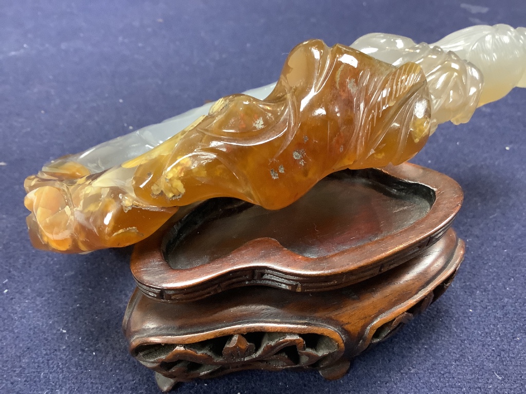 An early 20th century Chinese agate group of Guanyin and two boys, wood stand